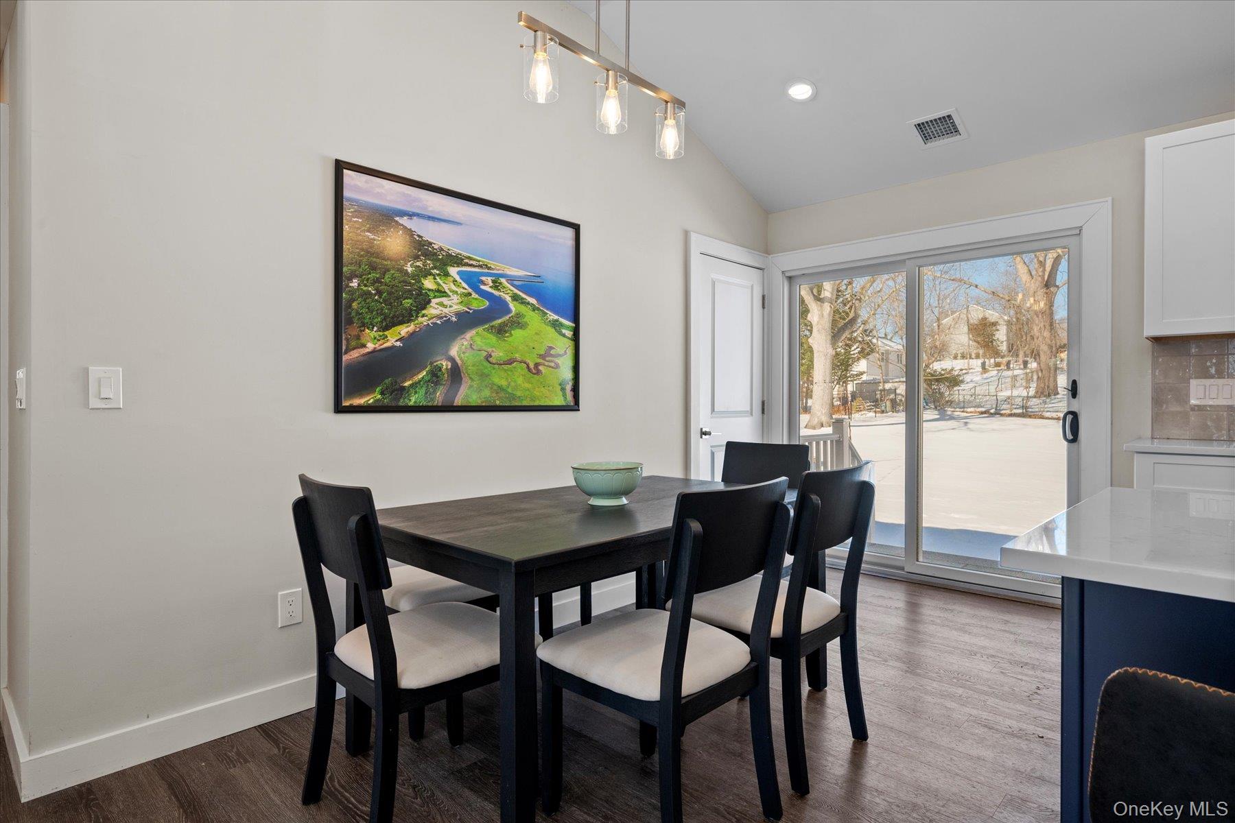 1150 Ruth Road Mattituck, NY 11952 - Photo 8 of 19 a view of a dining room with furniture large window and wooden floor
