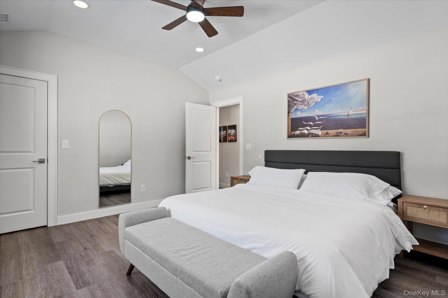 1150 Ruth Road Mattituck, NY 11952 - Photo 10 of 19 a bedroom with a large bed and a chandelier