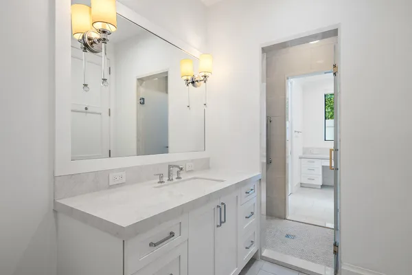 a bathroom with a sink a light fixture a vanity and a mirror