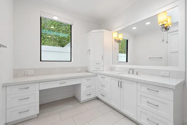 a bathroom with a double vanity sink a mirror and a bathtub
