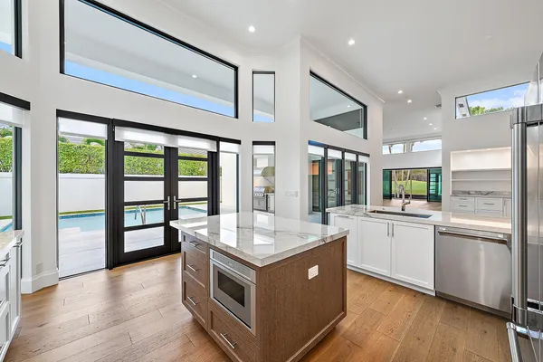 a kitchen with stainless steel appliances granite countertop a stove and a sink