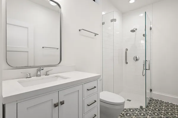 a bathroom with a sink toilet and shower