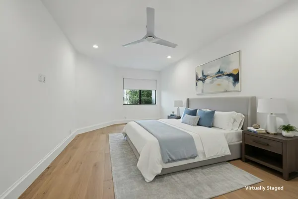 a bedroom with a large bed and a window