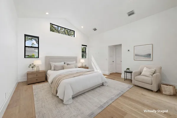 a spacious bedroom with a bed and a couch