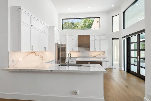 a bathroom with a granite countertop sink and a large mirror