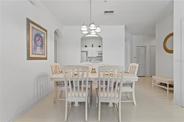 a view of a dining room with furniture and chandelier