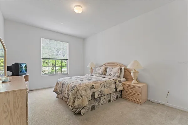 a bedroom with bed and a window