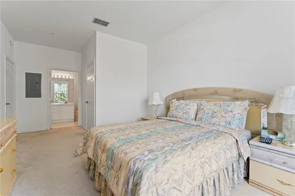 a bedroom with a bed and a lamp