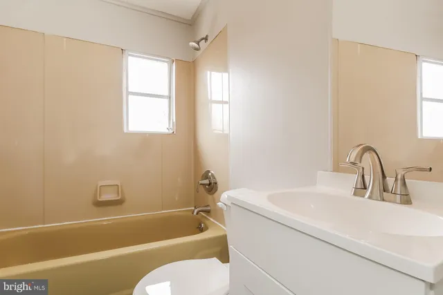 a bathroom with a sink toilet and bathtub