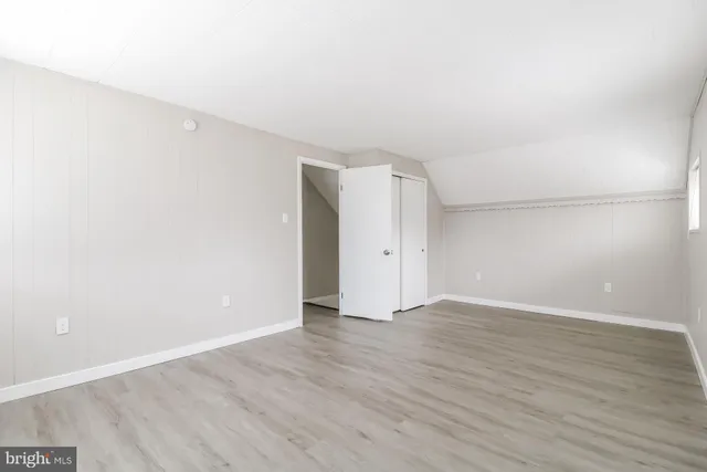 an empty room with wooden floor