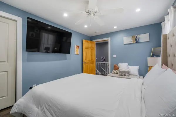 a bedroom with a bed window and television