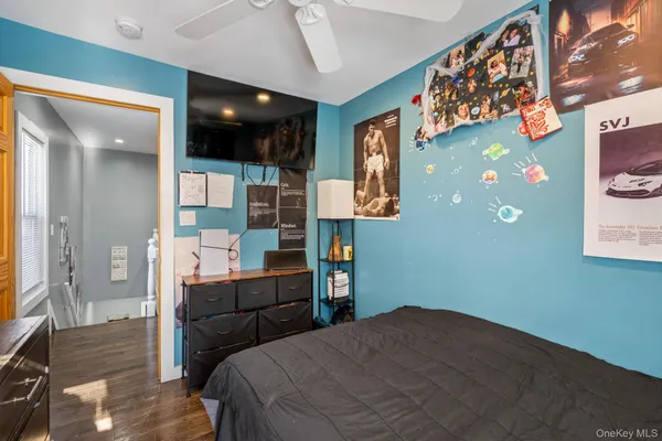 a bedroom with a bed and glass wall