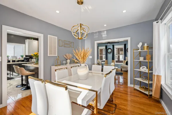 a view of a dining room and livingroom with furniture wooden floor and a rug