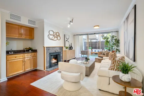 a living room with furniture fireplace and a large window