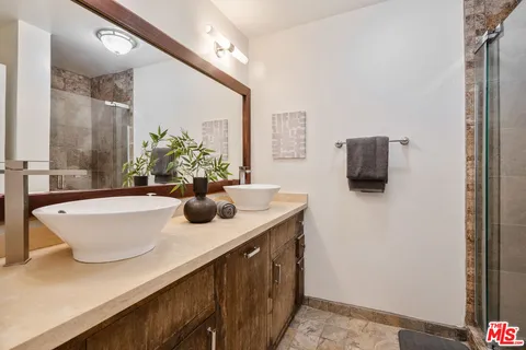 a bathroom with a sink a mirror and window
