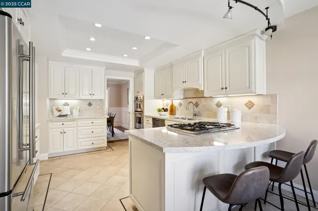 a view of a dining room with furniture and a chandelier