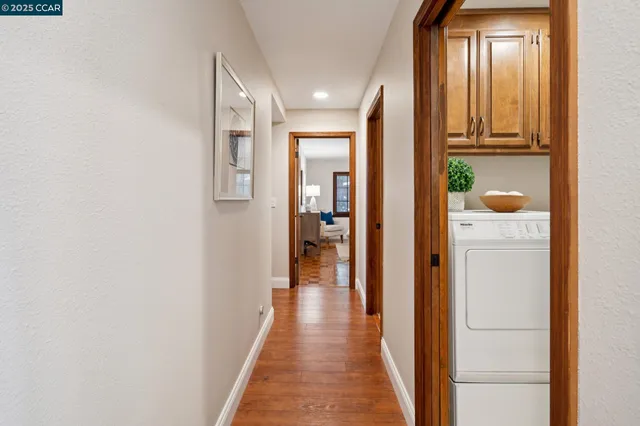 a bedroom with a large bed and a view of living room