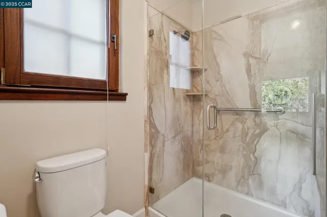 a bathroom with a tub a sink and a large mirror