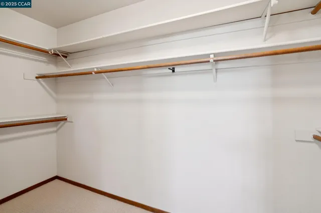 a bathroom with a double vanity sink toilet and mirror