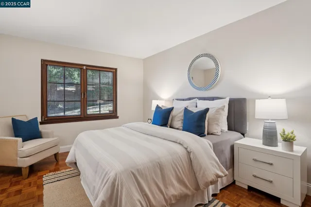 a living room with furniture potted plant and a large window