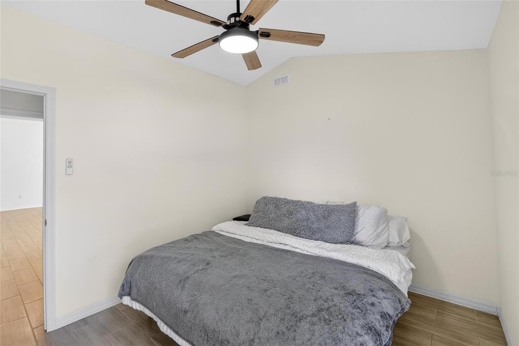 15047 Woodbury Road Brooksville, FL 34604 - Photo 24 of 98 a bedroom with a bed and a ceiling fan