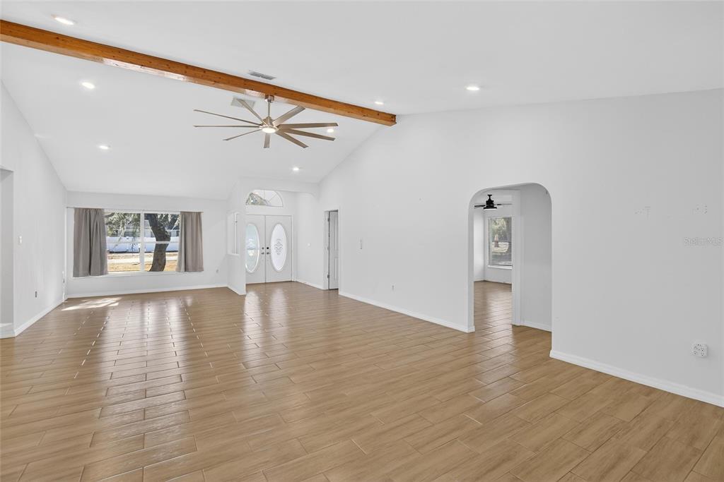 15047 Woodbury Road Brooksville, FL 34604 - Photo 33 of 98 a view of empty room with wooden floor and fan