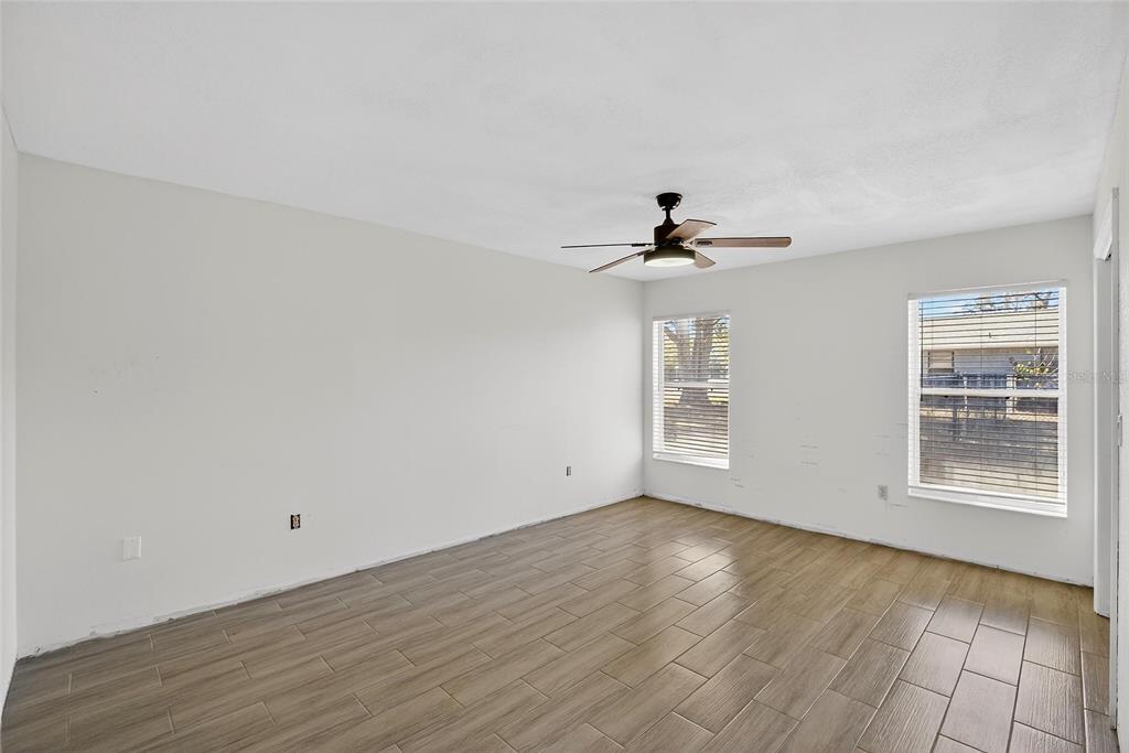 15047 Woodbury Road Brooksville, FL 34604 - Photo 43 of 98 a view of an empty room with wooden floor and a window