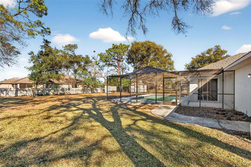 15047 Woodbury Road Brooksville, FL 34604 - Photo 61 of 98 a view of a yard with swimming pool