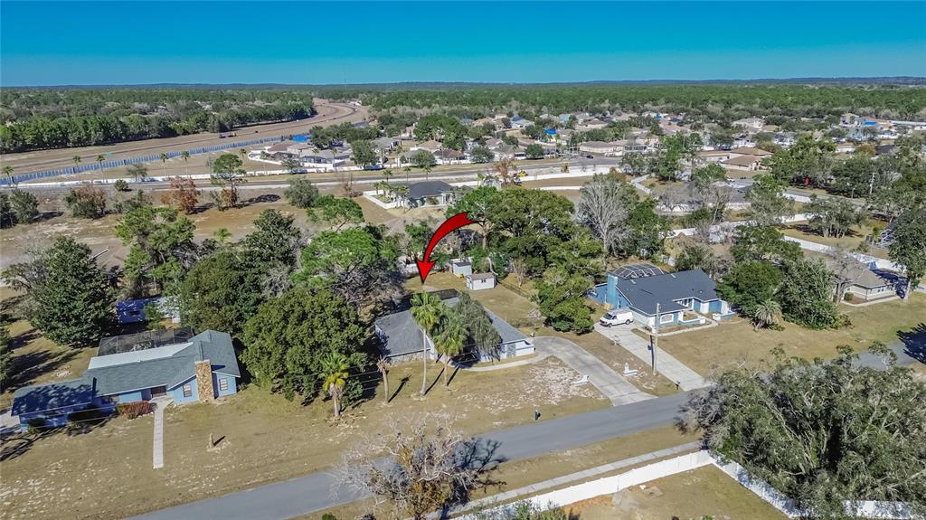 15047 Woodbury Road Brooksville, FL 34604 - Photo 83 of 98 an aerial view of residential houses with outdoor space
