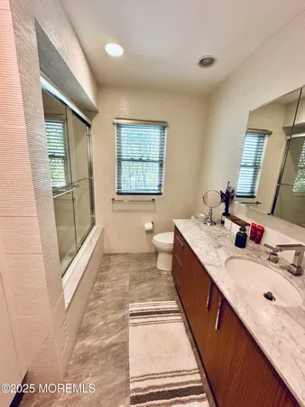 a bedroom with two beds and window