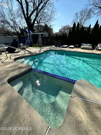 a view of a backyard with swimming pool