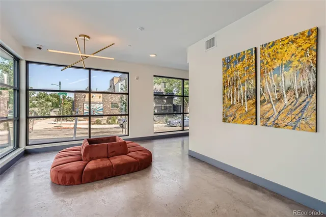 a living room with furniture and a potted plant