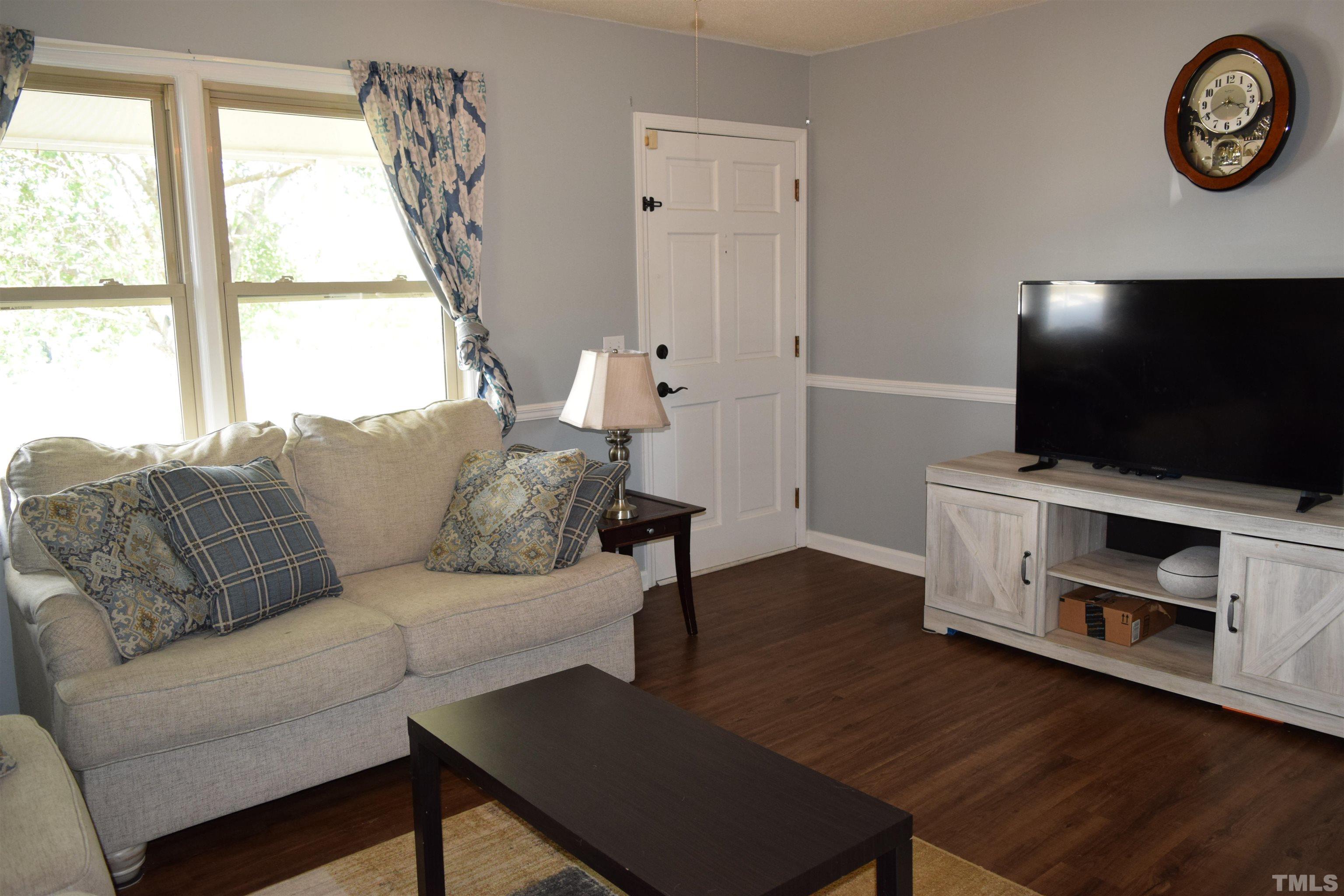 2451 Baileys Crossroads Road Coats, NC 27521 - Photo 4 of 13 a living room with furniture and a flat screen tv