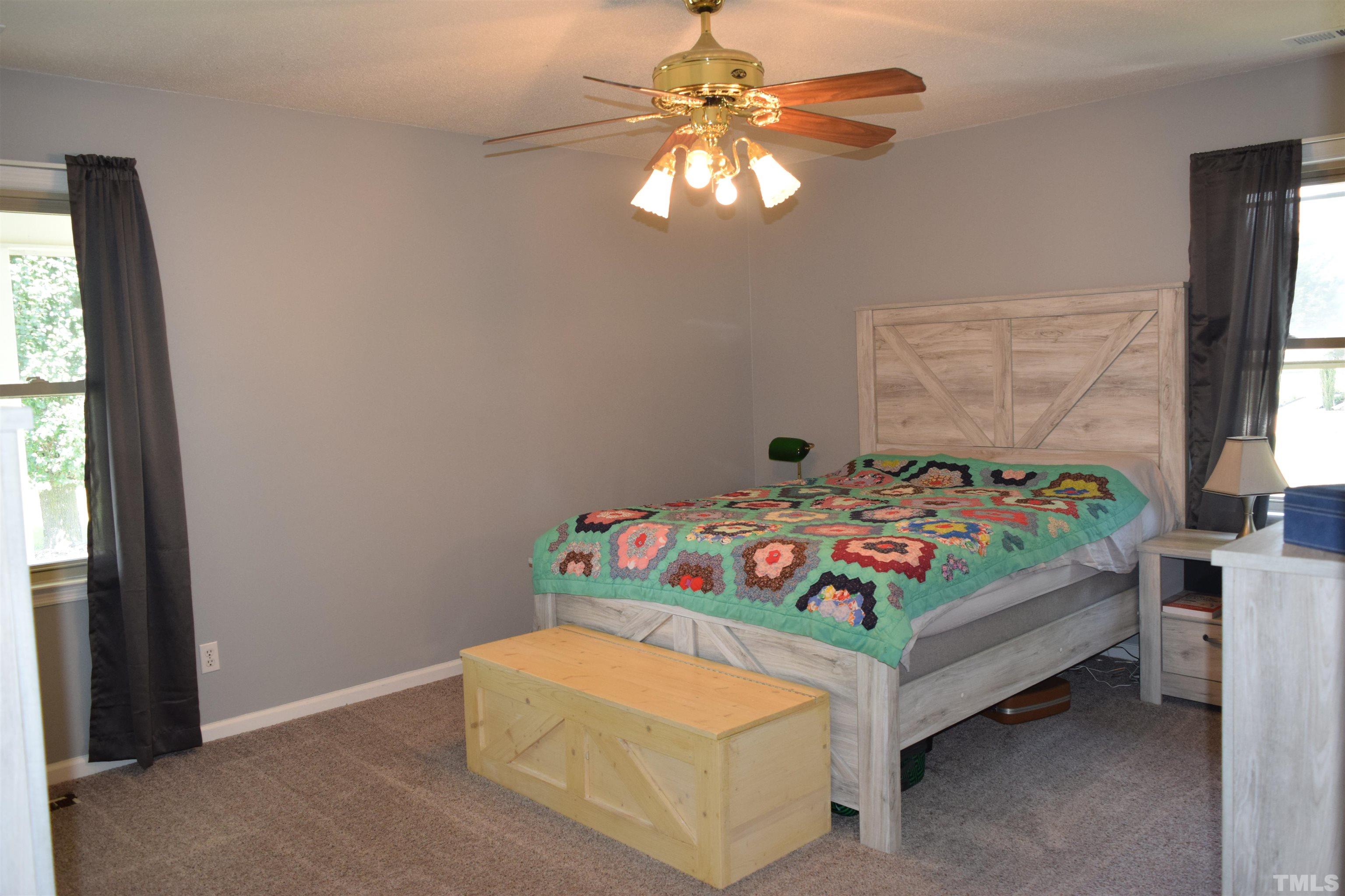 2451 Baileys Crossroads Road Coats, NC 27521 - Photo 5 of 13 a bedroom with a bed and a chandelier