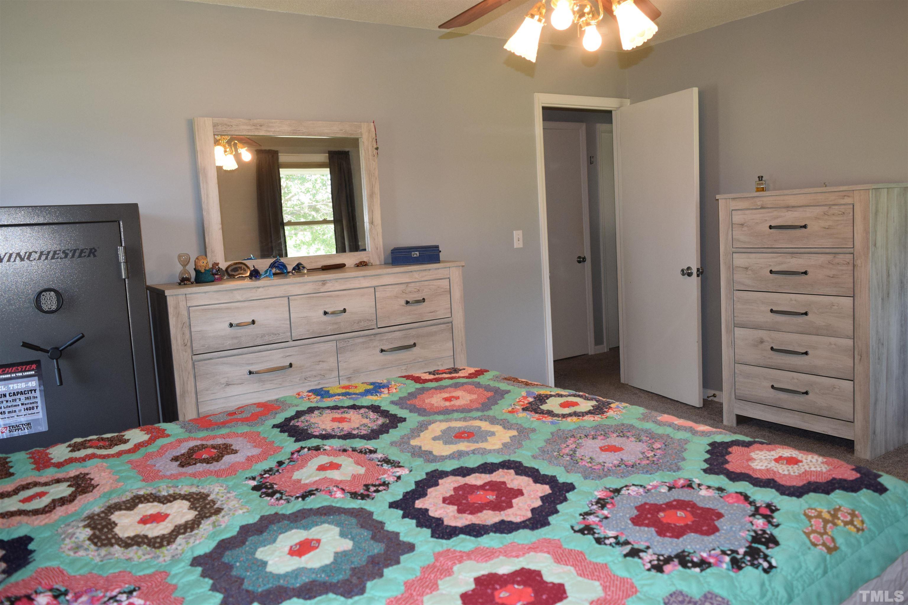 2451 Baileys Crossroads Road Coats, NC 27521 - Photo 6 of 13 a bedroom with a bed and a dresser in it