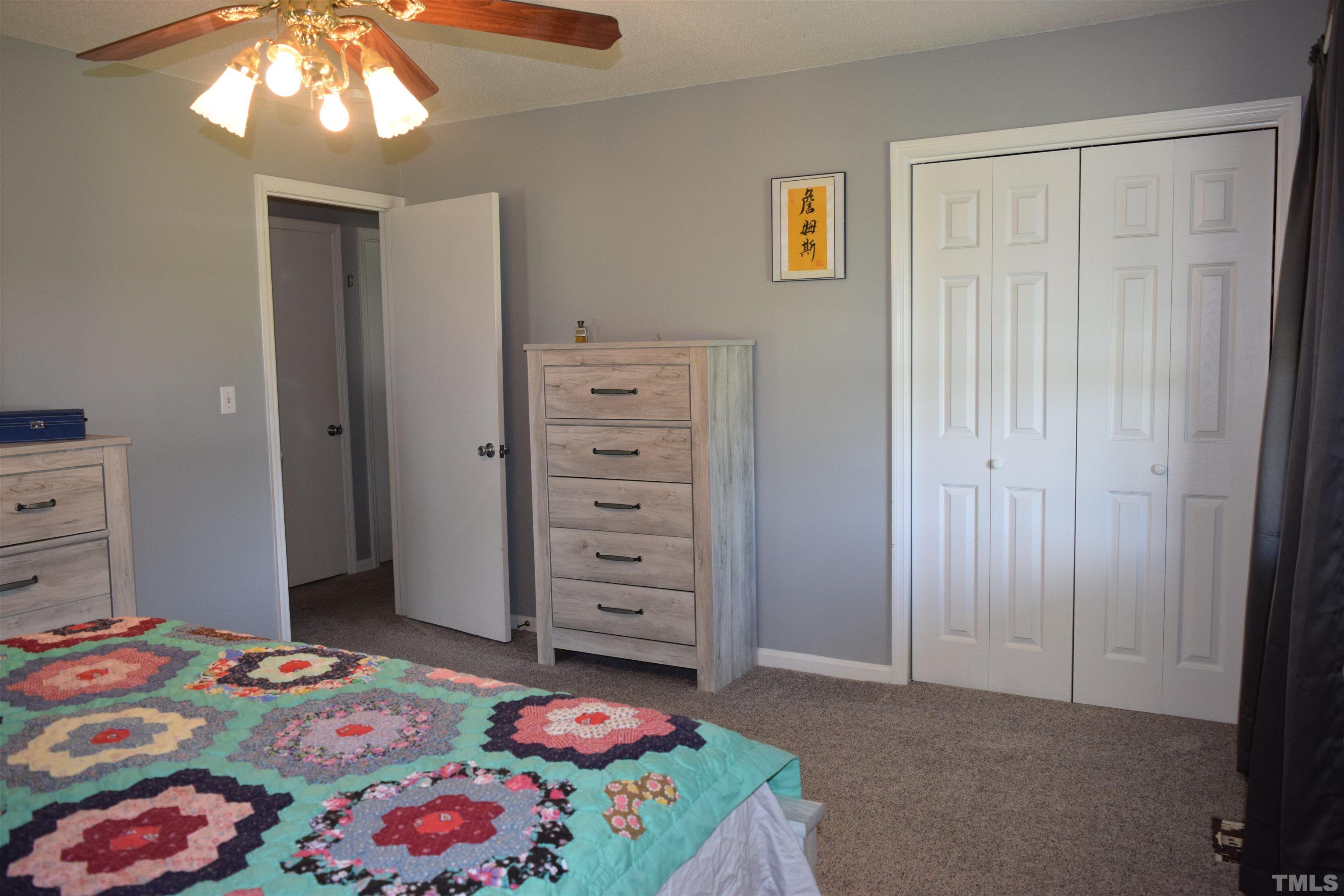 2451 Baileys Crossroads Road Coats, NC 27521 - Photo 7 of 13 a bedroom with a bed and a dresser in it