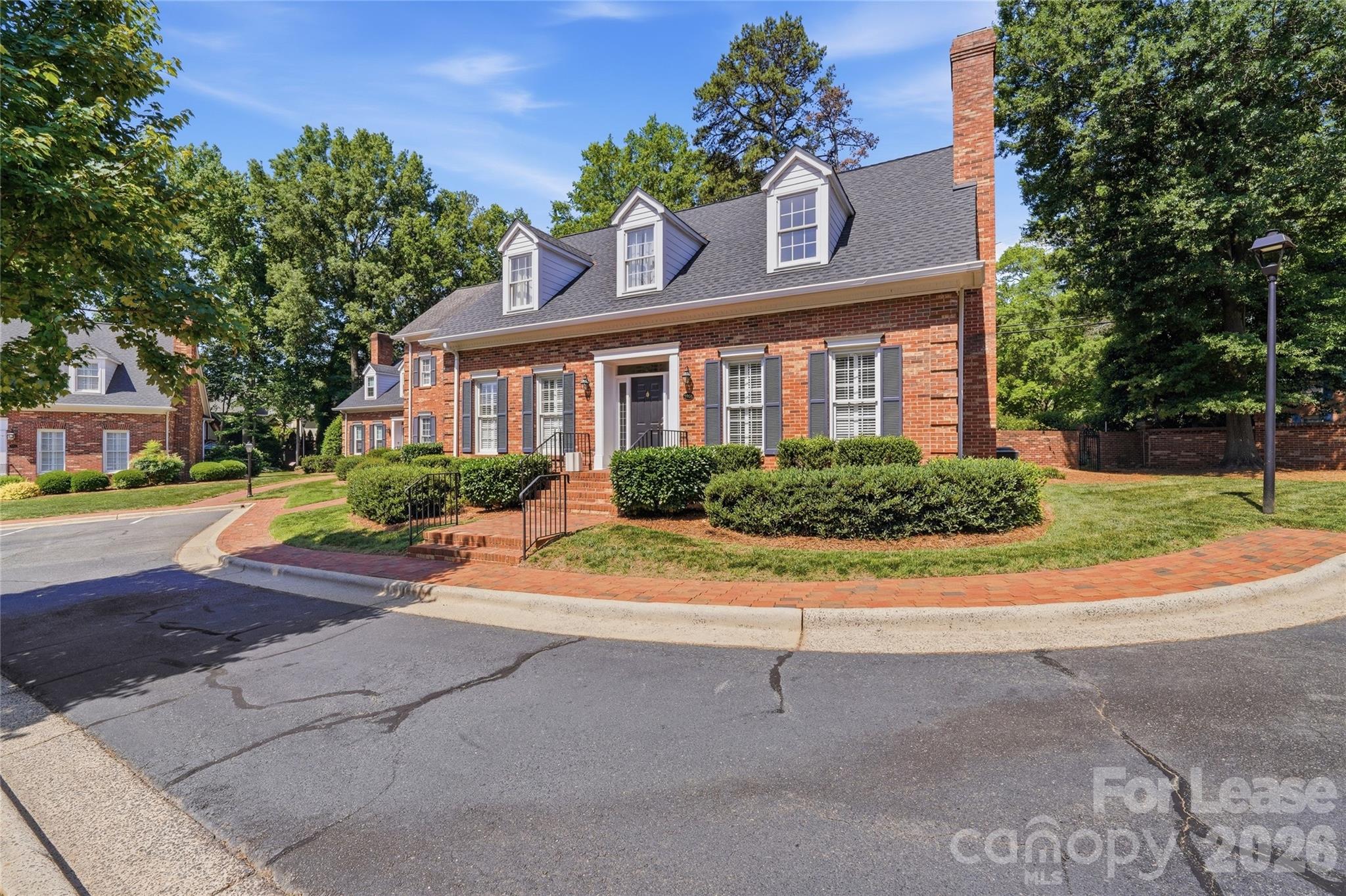 5906 Sharon Hills Road Charlotte, NC 28210 - Photo 29 of 30 a front view of a house with a yard and a garage