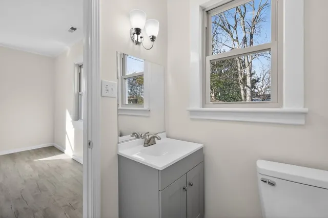 a bathroom with a sink mirror and vanity