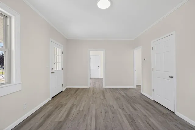 wooden floor in an empty room with a window