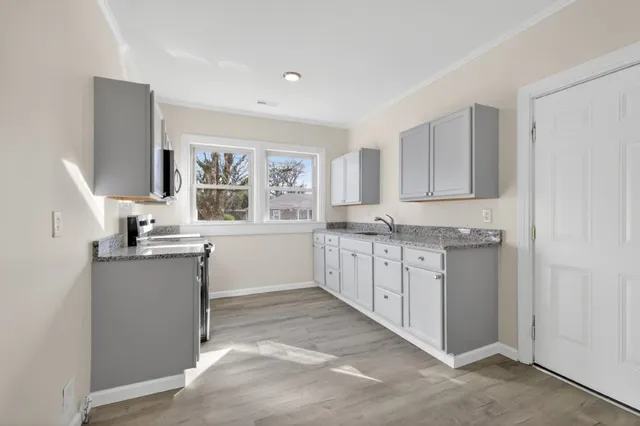 a kitchen with sink cabinets and window