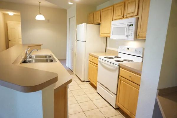 a kitchen with a refrigerator a stove a sink and a refrigerator