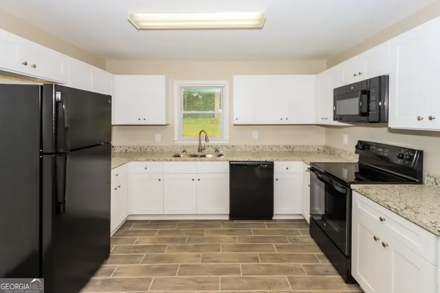 a kitchen with a sink stove and refrigerator