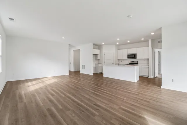 a view of kitchen with wooden floor and windows