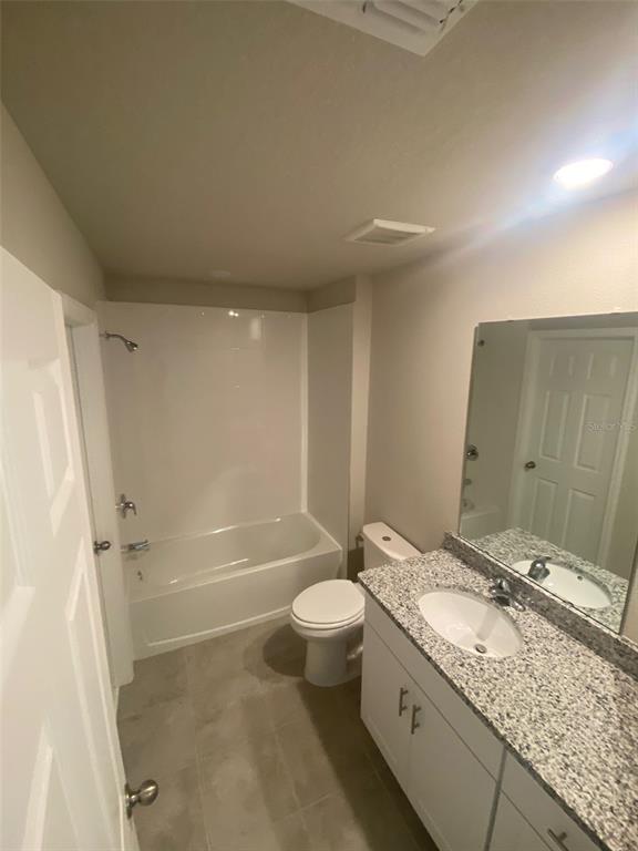 2053 Milkweed Street Ocoee, FL 34761 - Photo 12 of 17 a bathroom with a granite countertop sink a toilet and shower