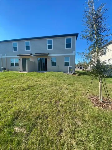 a view of a house with a backyard