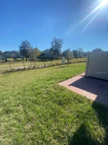 a view of a field of grass and a building