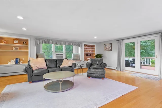 a living room with furniture and large windows