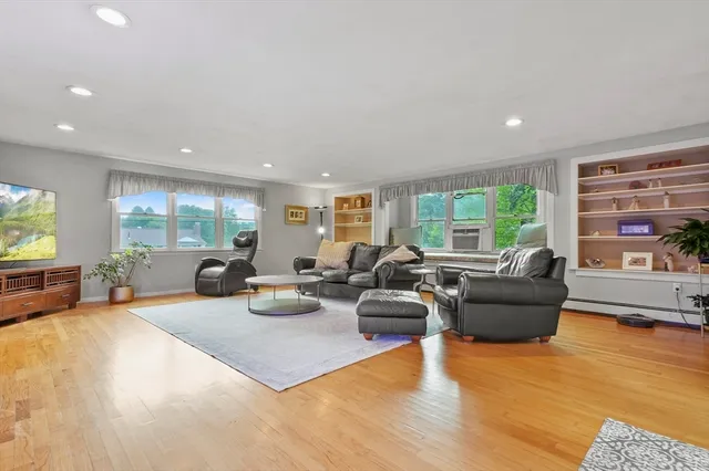 a bedroom with a bed and hallway with wooden floor
