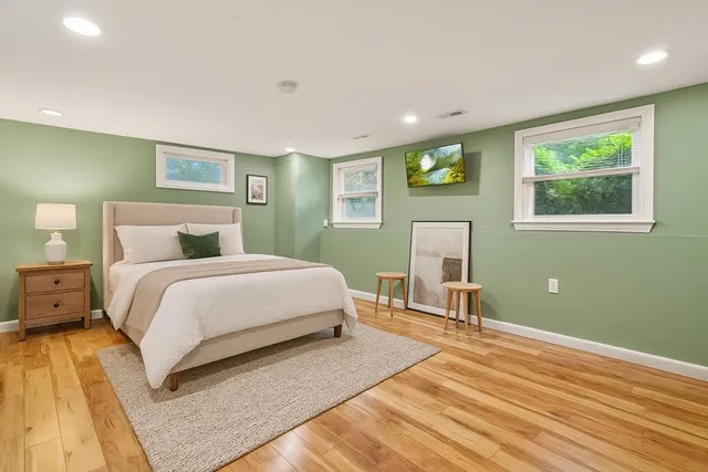 a view of a patio with couches table and chairs with wooden floor and fence