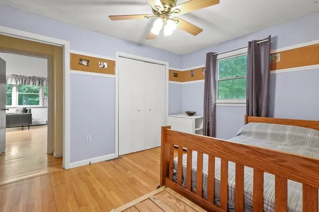 a bedroom with a bed window and a couch